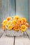 Bouquet of orange roses in a white wicker basket