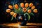 Bouquet of orange tulips in a vase on a black background