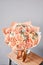 Bouquet Peach and orange color. Beautiful bunch mixed flowers in wooden table. the work of the florist at a flower shop