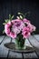 Bouquet of pink flowers in vase vintage decor