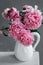 Bouquet of pink peonies in a jug