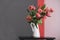 A bouquet of pink peony tulips in a white jug.