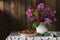 Bouquet of pink Phlox and purple ageratum in a white jug and strawberries