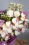 Bouquet of pink roses, alstroemeria flowers and orchids. Fresh summer flowers on gray background