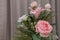 A bouquet of pink roses on gray curtain background