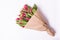 Bouquet of a pink tulips lying isolated on background white Kraft paper