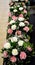 Bouquet of pink and white carnation flowers, white tiny flowers and green leaves of areca palm etc. Fresh flowers