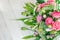 Bouquet of pink white green flowers arranged on wooden background. Roses, sedum, hosta, seed pods and grasses