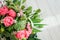 Bouquet of pink white green flowers arranged on wooden background. Roses, sedum, hosta, seed pods and grasses