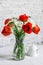 Bouquet of poppies and daisies on the table in a bright room. Home interior beauty comfort concept