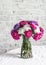 Bouquet purple aster flowers on the kitchen table on a light background. Cozy home concept