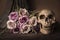 Bouquet purple roses with human skull