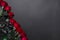 Bouquet of red roses on corner of black colored paper background, with copy space