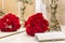 Bouquet of red roses reflected in the mirror, white clutch, flowers