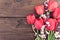 Bouquet of red tulips on a wooden background with space for text