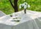 bouquet of roses and  cake on plate on the table in the garden