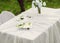 bouquet of roses and  cake on plate on the table in the garden