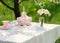 bouquet of roses and  cup on the table in the garden