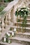 Bouquet of roses on a pedestal stands on stone steps near the balustrade