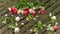 Bouquet of roses, white and pink, thrown over the wooden bridge to the lake on a rainy day