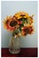 Bouquet of rustic red and yellow sunflower bouquet in a glass vase still-life