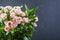 Bouquet of several branches of pink roses. Background of pink roses