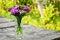 Bouquet of small carnations on a table in the garden