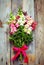 Bouquet of snapdragon (Antirrhinum majus) on vintage wooden boar