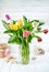 Bouquet spring tulip at white wooden board