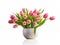 Bouquet of spring tulips pink and yellow in a white ceramic vase. Congratulations on Mother\\\'s Day, Easter, March 8