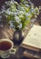 Bouquet of summer blue flowers, cup of tea and vintage books