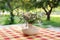 Bouquet of summer flowers in ceramic vase on table on terrace. Fresh Field flowers in vase, closeup. Cozy home decor of patio yard