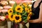Bouquet sunflowers flower shop female florist holding