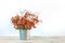 Bouquet of tansy flowers on the table, white background, autumn concept