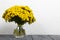 A bouquet of tansy in a glass goblet. On a white background