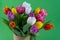 Bouquet of tulips. Flower delivery. Green background . Tulip.