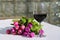 A bouquet of tulips with a glass of wine on a garden table