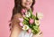 Bouquet of tulips in hands of unrecognizable happy woman