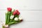 Bouquet of tulips on white wooden table, copy space for text. Invitation or congratulation banner mockup for spring holidays, Inte