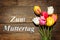 Bouquet of Tulips on wooden background and german words motherÂ´s day