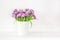 Bouquet of violet tulips in bucket. Fresh spring easter flower. Woman& x27;s day greeting card. White background , copy space