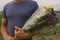 Bouquet of violet, yellow, pink and white statis in the man`s hands