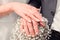 Bouquet of white color gypsophila with a pair of hands with wedding rings, for a wedding ceremony, soft focus