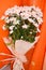 Bouquet of white daisy flowers on a orange background