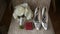 A bouquet of white flowers, wedding rings and woman shoes.