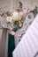 Bouquet of white hydrangea and pink ranunculus on piano case