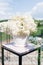 Bouquet of white hydrangea in a white vase in the decor of the exit registration of marriage
