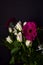 Bouquet of white roses and chrysantemums and purple gerberas and roses on a black background