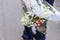 Bouquet of white roses close-up and blurred boys legs in the background