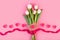 Bouquet of white tulips, hearts, envelope love letter on pink background